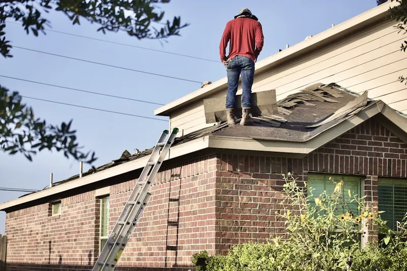 Professional roofer working on a residential roof in Fairway Estates